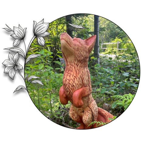 A carved juvenile red fox standing on his hind legs